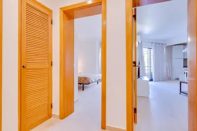 a door leading into a room with a bedroom at Tália II - City Center - Vilamoura in Vilamoura