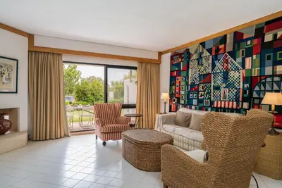 a living room with a couch and chairs at BmyGuest - Quinta do Lago Garden Apartment in Almancil