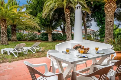 a palm tree in front of a house at BmyGuest - Falésia Beach Villa in Albufeira