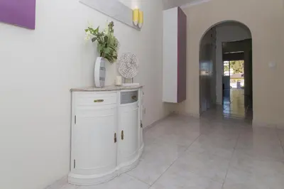 a room with a white cabinet with a plant on it at Boas-Vindas in Albufeira