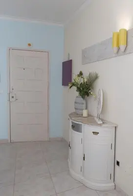 a room with a white door and a table with a plant at Boas-Vindas in Albufeira
