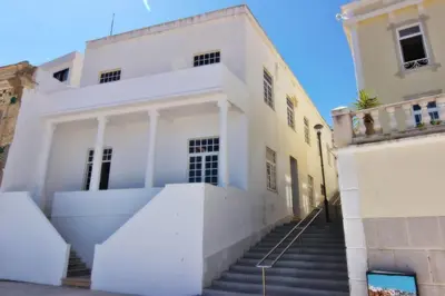a white house with stairs in front of it at Casa dos Tios in Albufeira