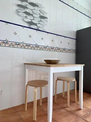 a table and two stools in a room at Vilamoura - Cozy and Quiet Holiday Apartment in Vilamoura