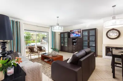 a living room with a couch and a tv in it at Decor n' cozy place for families and friends in Guia