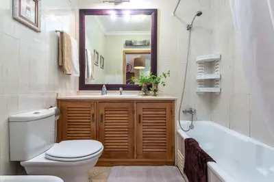a bathroom with a toilet and a sink and a tub at Decor n' cozy place for families and friends in Guia
