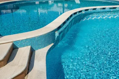 a large swimming pool with blue water at Decor n' cozy place for families and friends in Guia