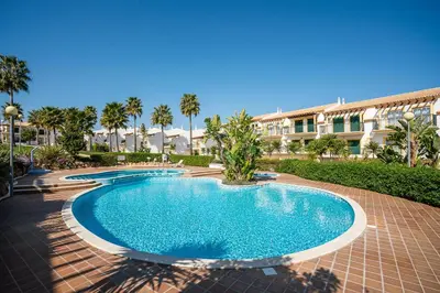 a swimming pool in front of a building at Decor n' cozy place for families and friends in Guia