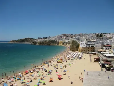 a group of people on a beach near the water at Albufeira Sunny Home for Families in Albufeira