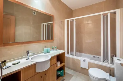 a bathroom with a sink and a toilet and a shower at Epic Falésia Apartment by The Portuguese Butler in Olhos de Água