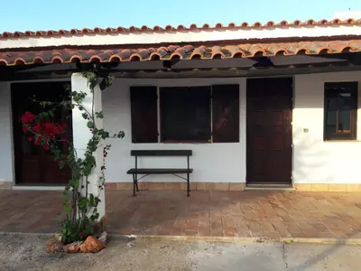 a bench in front of a white building with windows at Quinta Cosy in Paderne