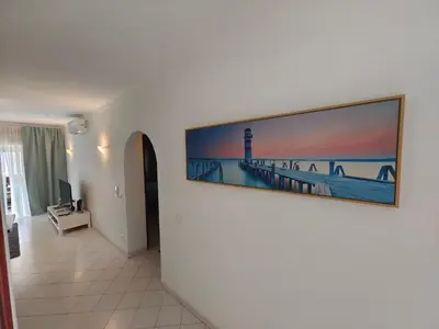 a living room with a painting of a pier at Albufeira Center Old Town, 8ppl, 5min Fishermans beach in Albufeira