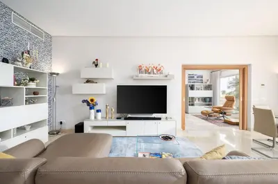 a living room with a couch and a flat screen tv at Villa Mebahel - Boliqueime in Boliqueime