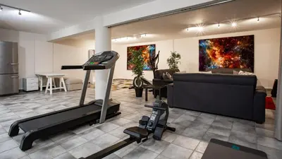 a gym with a treadmill and a living room at Villa Mebahel - Boliqueime in Boliqueime