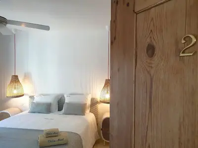 a bedroom with a bed and a wooden wall at Villa Azul - Clever Details, Luxury villa, private pool, access to a club with tennis court, playground, communal pools in Vilamoura