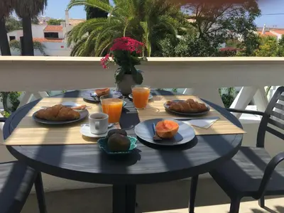 a table with breakfast food on a balcony at Algarve Beach House with Heated Pool and Jacuzzi in Albufeira