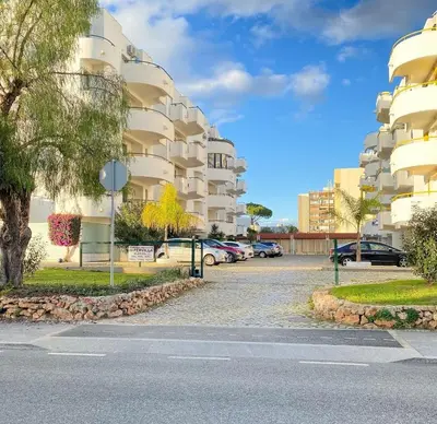 a parking lot in front of a building at AL - R&R Vilamoura Flat, City Center in Vilamoura