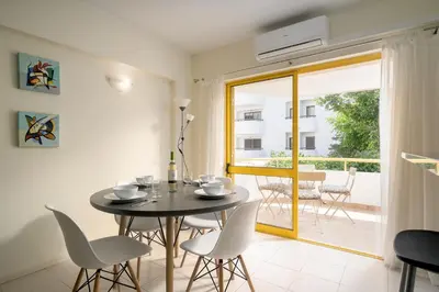 a white bathroom with a sink and a mirror at AL - R&R Vilamoura Flat, City Center in Vilamoura