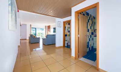 a hallway with a door and a living room at Penthouse 160sqm wide Terraces Pool view & private Hot Tub & Parking in Albufeira