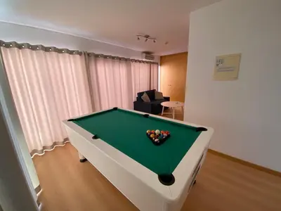 a room with a pool table in a living room at Penthouse 160sqm wide Terraces Pool view & private Hot Tub & Parking in Albufeira