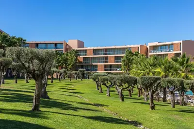 a park with trees in front of a building at Apartamentos Vila das Lagoas – Salgados in Guia