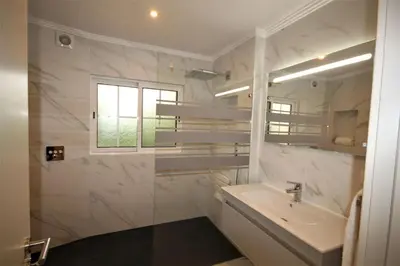 a white bathroom with a sink and a window at Casa Roma in Almancil