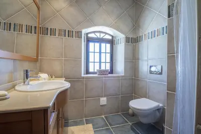 a bathroom with a sink and a mirror and a shower at Villa Angel in Loulé