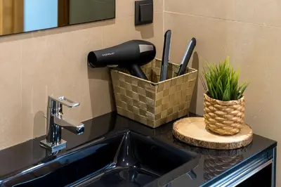 a kitchen counter with a sink and a knife holder at Downtown Pool House in Faro