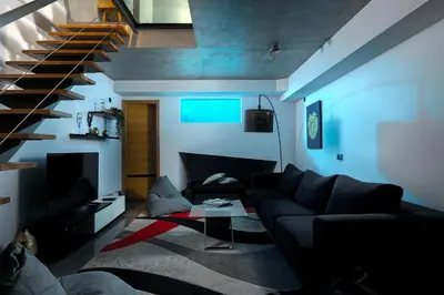 a living room with a couch and a staircase at Downtown Pool House in Faro