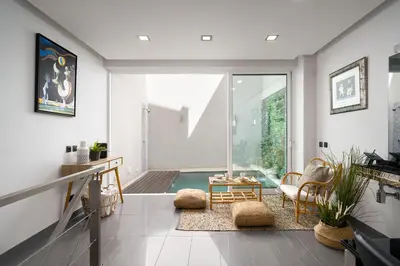 a living room with a view of a pool at Downtown Pool House in Faro