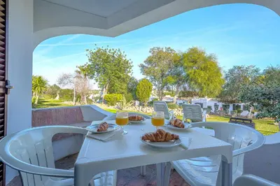 a white table with food and drinks on a patio at T2 Casa Albufeira - Pool & Sun Terrace in Albufeira