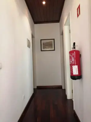 a hallway with a red fire hydrant in a room at Oura Villa V5 in Albufeira