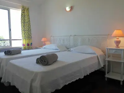 two twin beds in a bedroom with a window at Oura Villa V5 in Albufeira