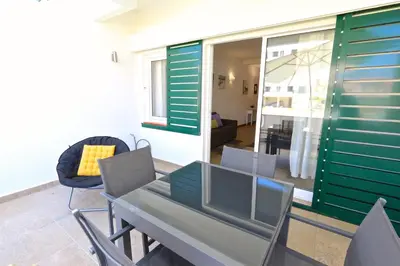 a dining table and chairs in a living room at Neptuno 97 - Clever Details in Vilamoura
