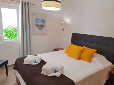 a bedroom with a bed with towels on it at Neptuno 97 - Clever Details in Vilamoura