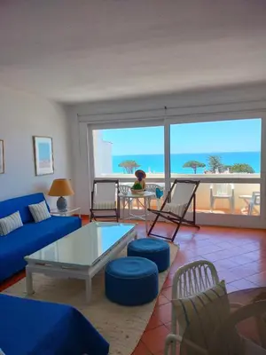 a living room with a blue couch and a table at Dreamly Sea in Albufeira
