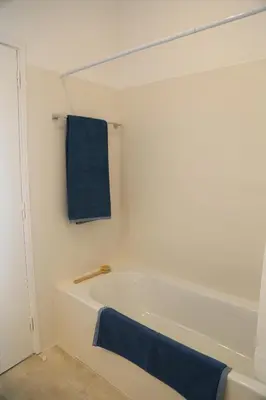 a bathroom with a bath tub with a blue towel at Dreamly Sea in Albufeira