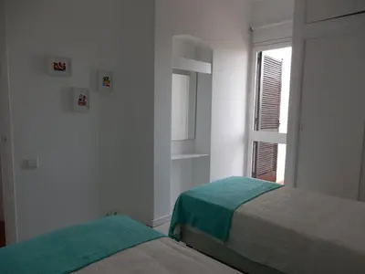 a white room with two beds and a window at Dreamly Sea in Albufeira