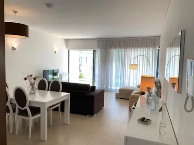 a living room with a couch and a table at Cavalo Preto Luxury Beach Resort in Quarteira
