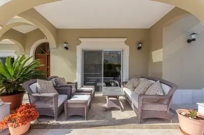 a patio with wicker chairs and a table at Villa Maureena - Quinta do Mar in Almancil