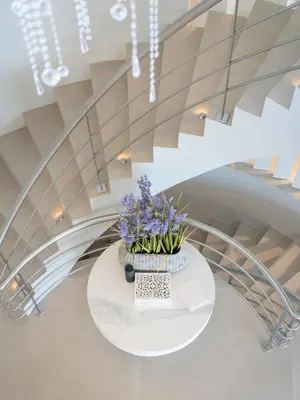 a staircase with a white table with purple flowers on it at Villa Croesa - Vale de Lobo in Almancil
