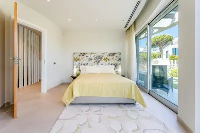 a bedroom with a bed and a large window at Villa Croesa - Vale de Lobo in Almancil