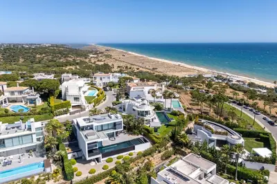 an aerial view of a beach with houses and the ocean at Villa Croesa - Vale de Lobo in Almancil