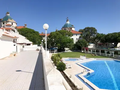 a view of a swimming pool and a building at Vilamoura Marina Apartment with swimming pool in Vilamoura