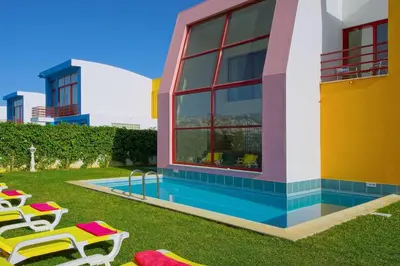 a house with a swimming pool and some lawn chairs at Vila Marina -BBQ, pool & garden- by Seareen in Albufeira