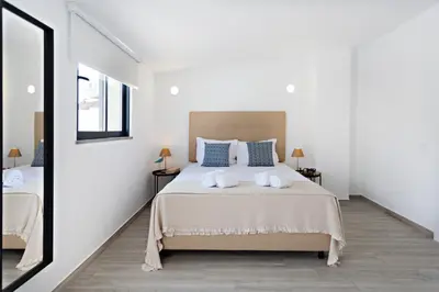 a bedroom with a bed with two towels on it at Faro Clara Suites in Faro