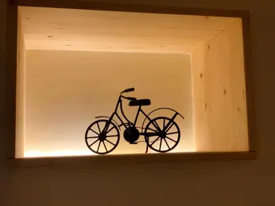 a bike is sitting in a light in a shelf at Charming Apartment with Private Garden & Pool in Vilamoura