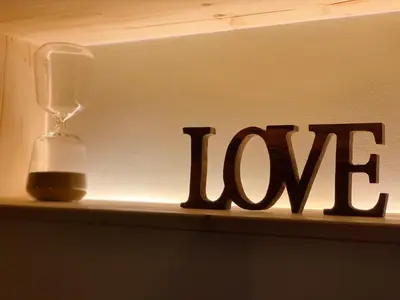 a shelf with the word love next to a lamp at Charming Apartment with Private Garden & Pool in Vilamoura