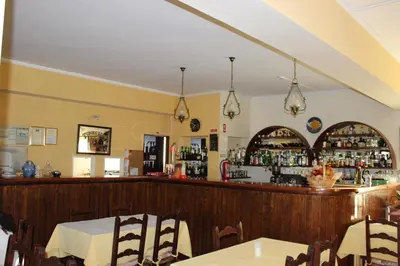 a restaurant with a bar with a table and chairs at Sunshine in Albufeira