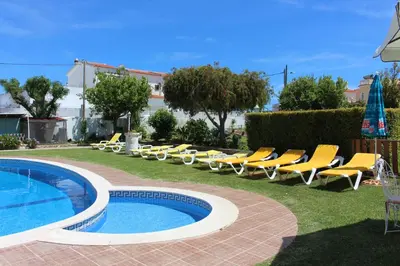 a group of chairs and a swimming pool at Sunshine in Albufeira