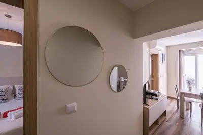 a bedroom with a mirror and a bed and a table at LovelyStay - Sweet Escape I - Terrace in Quarteira